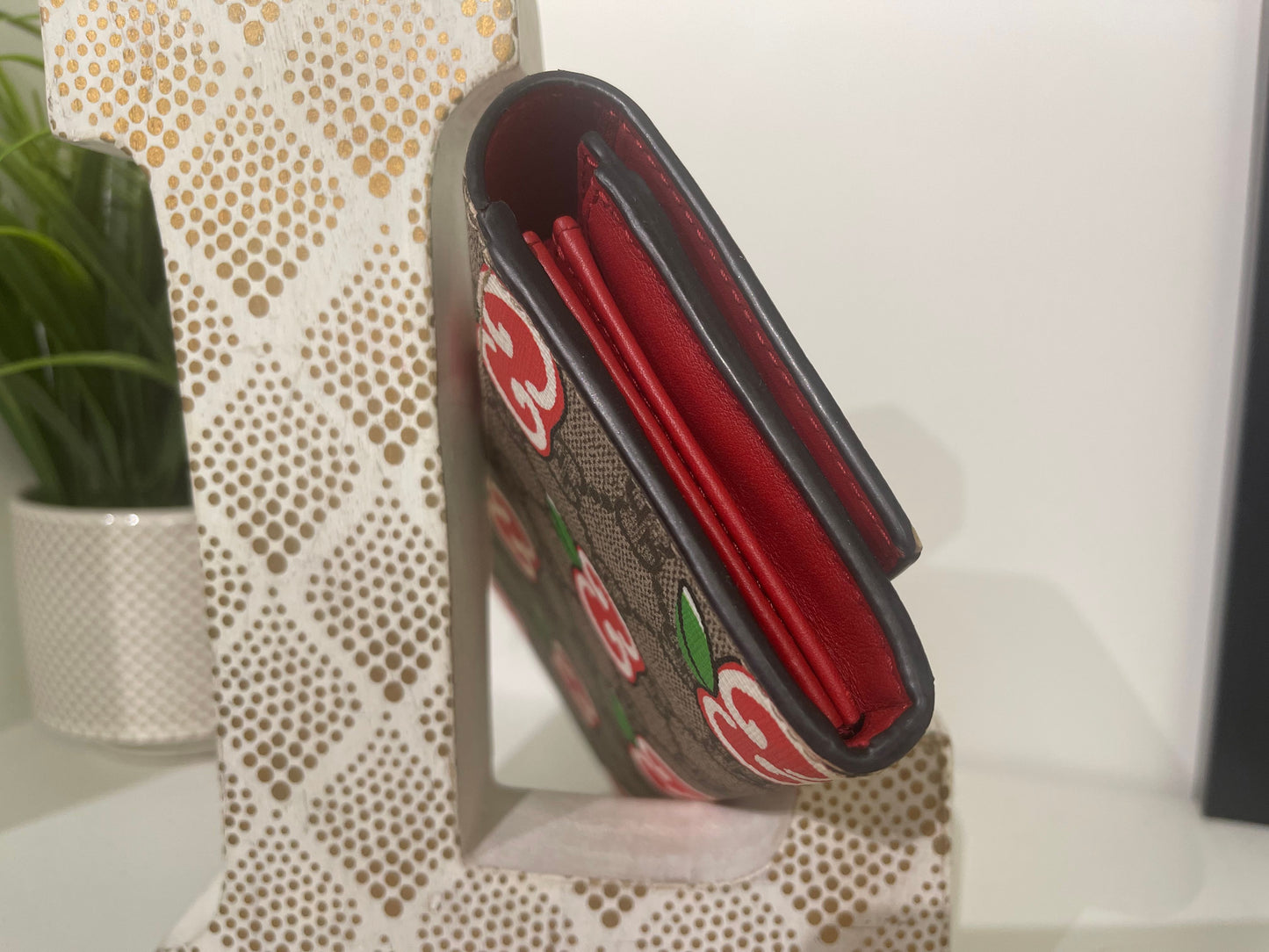 14. Gucci Supreme Apple Wallet