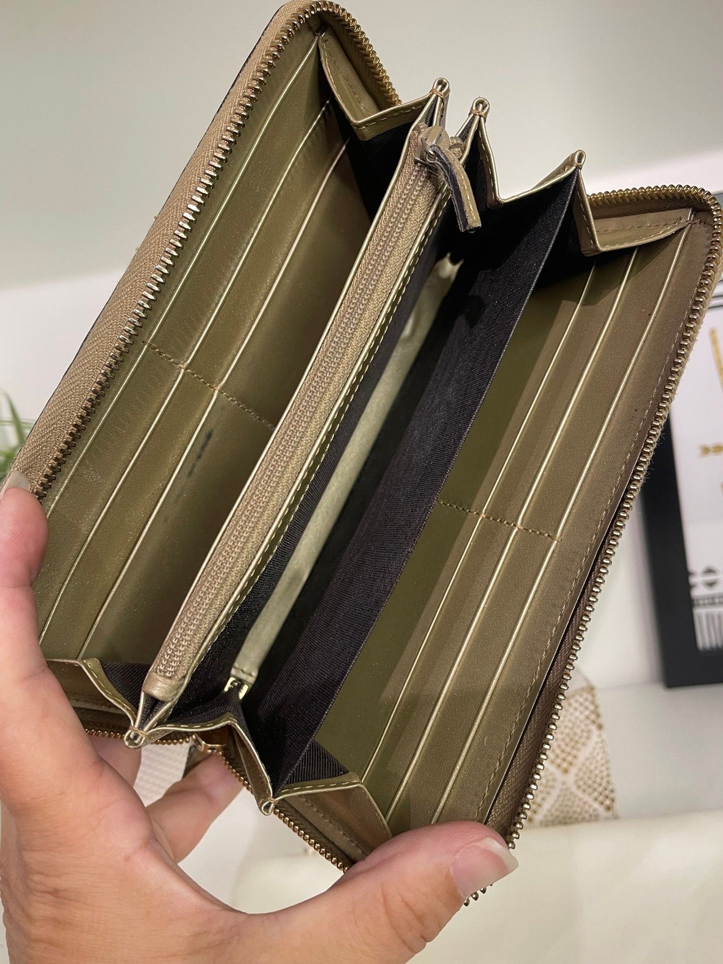 108. Gucci Metallic Gold Zippy Wallet