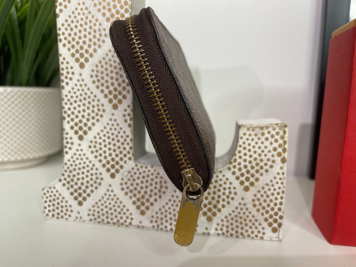 21. Louis Vuitton Damier Ebene Zippy Compact Wallet