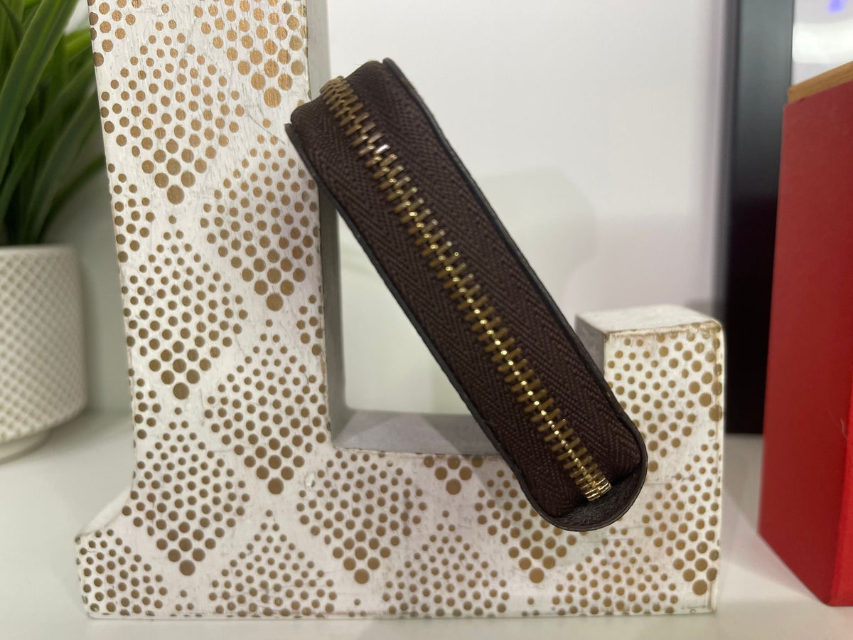21. Louis Vuitton Damier Ebene Zippy Compact Wallet