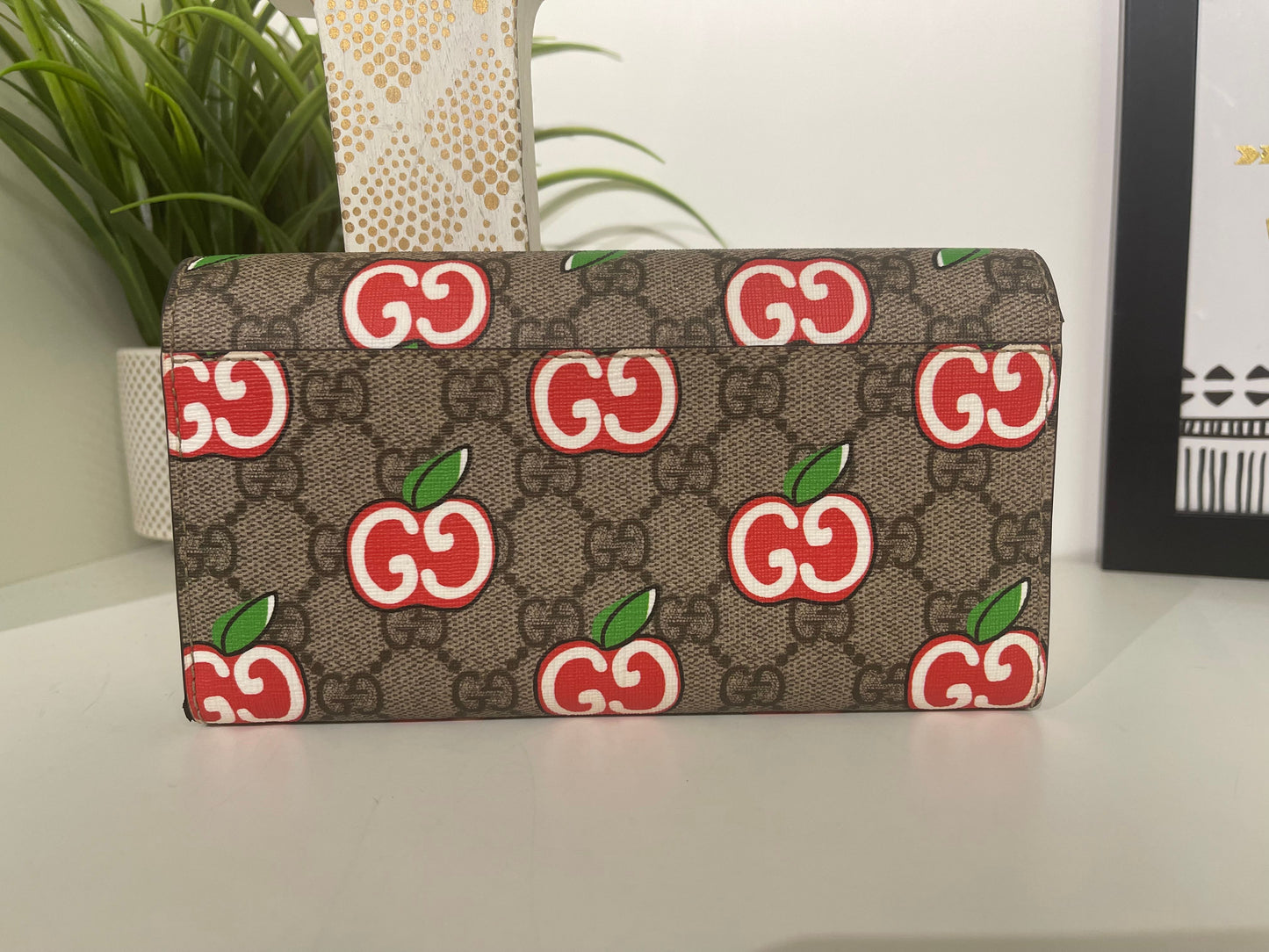 14. Gucci Supreme Apple Wallet