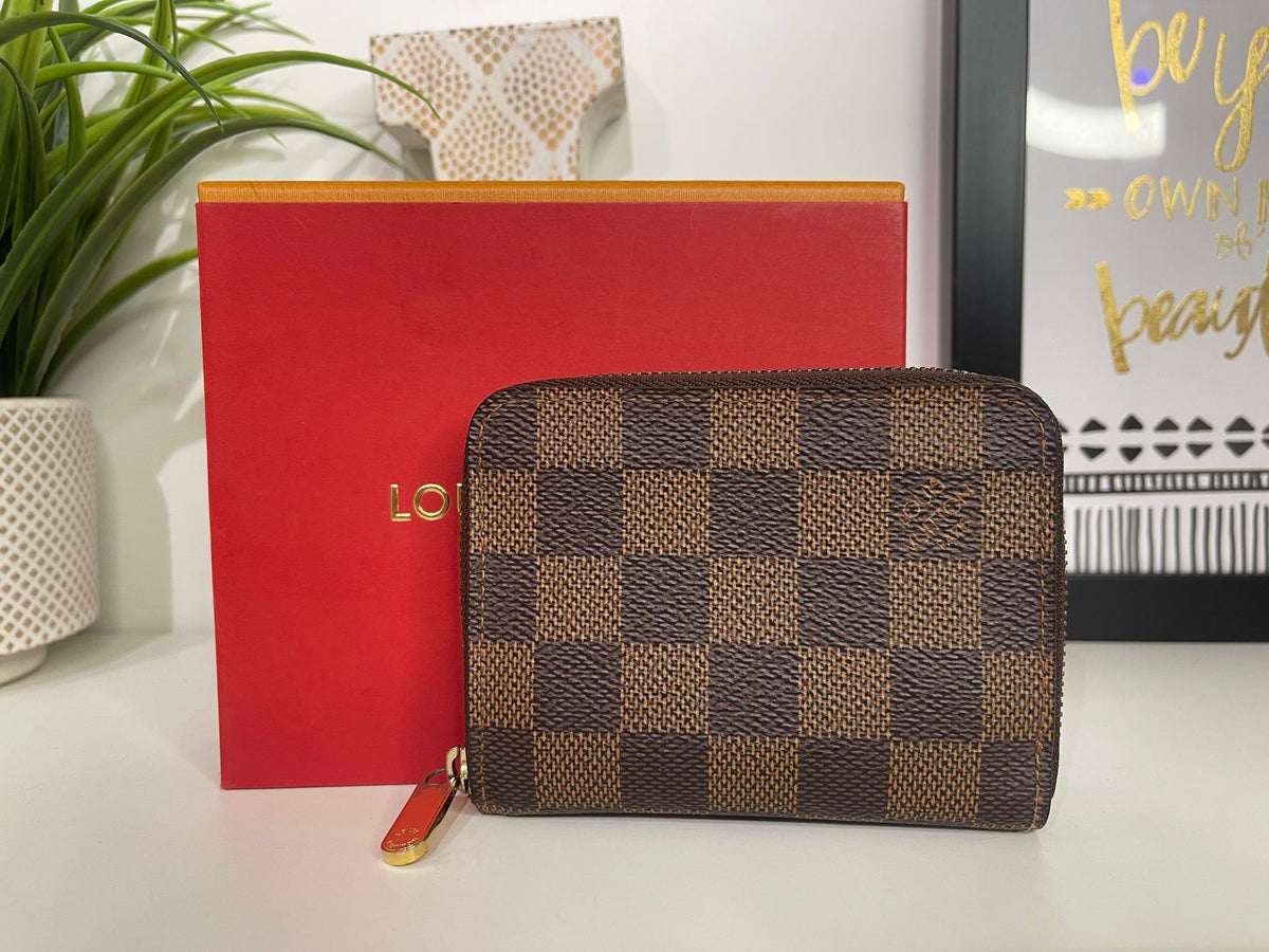 21. Louis Vuitton Damier Ebene Zippy Compact Wallet
