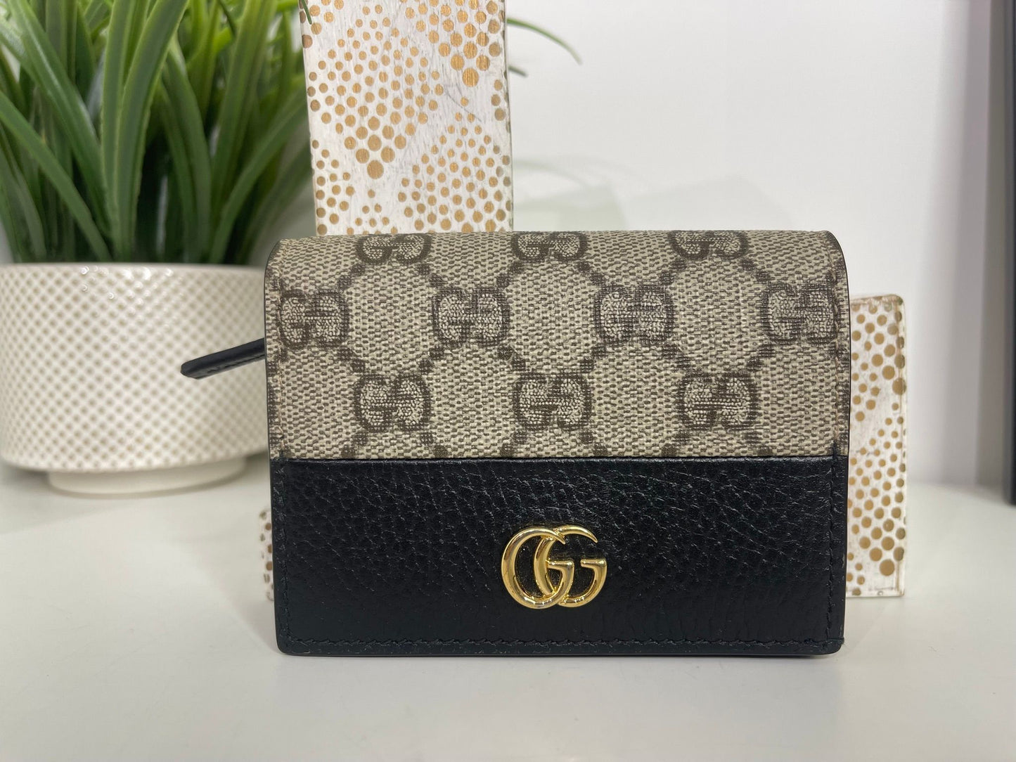 76. Gucci Supreme Compact Wallet Black Leather Trim
