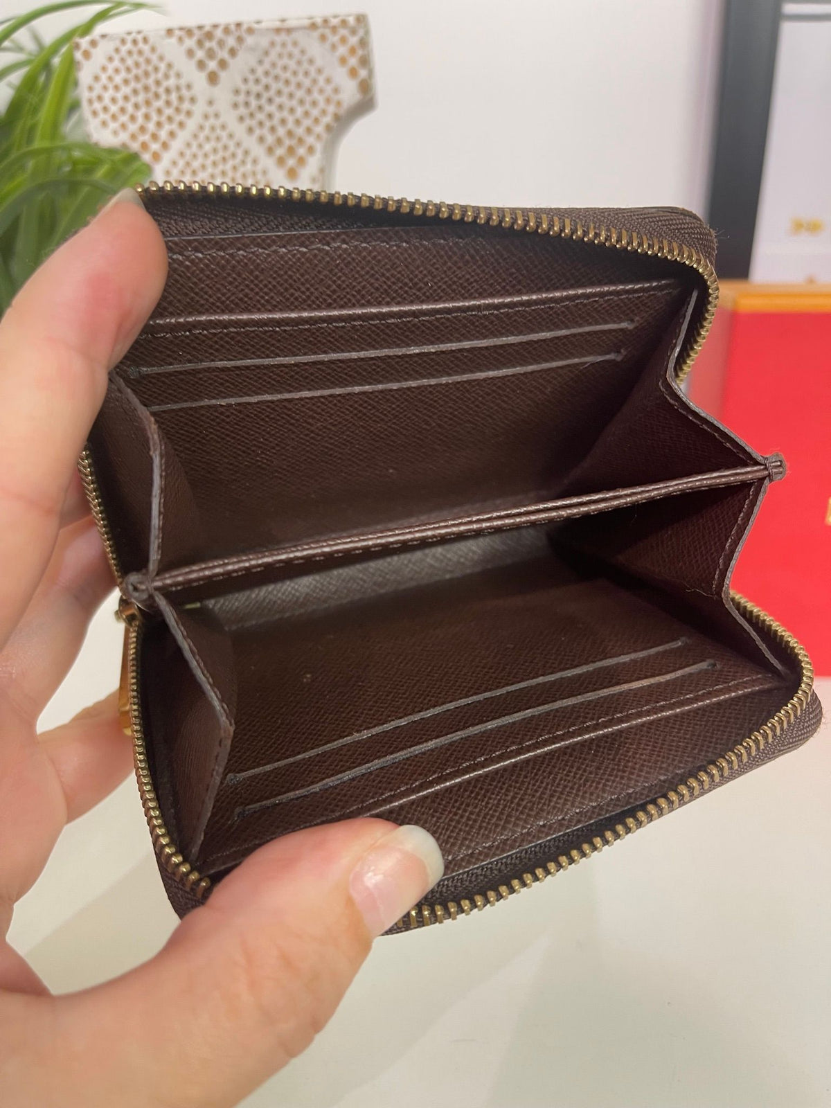 21. Louis Vuitton Damier Ebene Zippy Compact Wallet